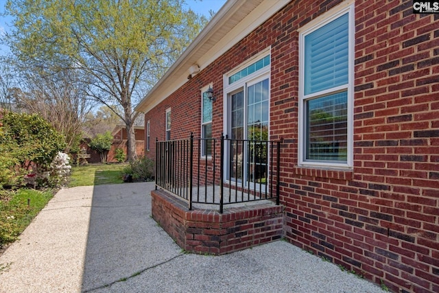 view of side of property with brick siding