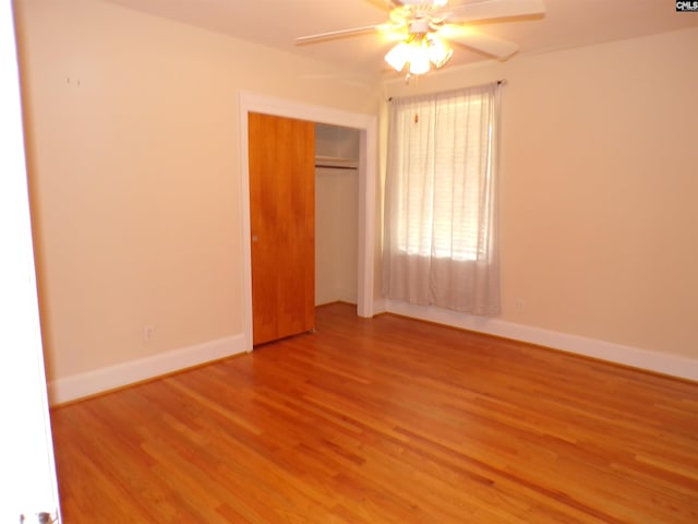 302 Baskin Ave, Bishopville, SC 29010 - unfurnished bedroom featuring baseboards, a closet, wood finished floors, and ceiling fan