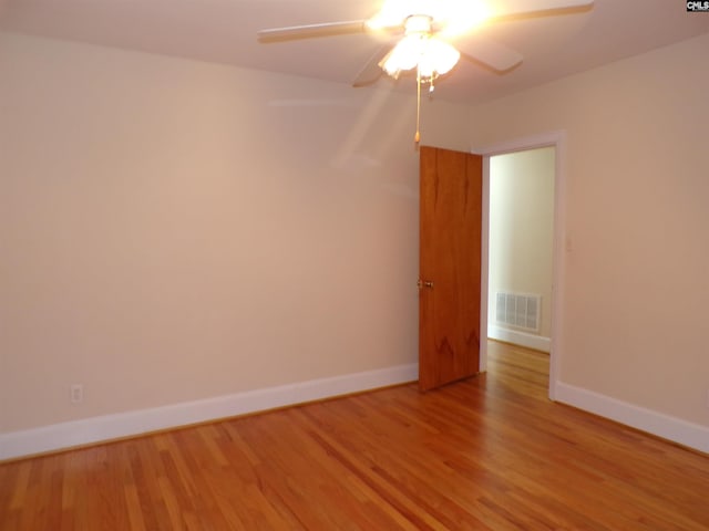 302 Baskin Ave, Bishopville, SC 29010 - unfurnished room with baseboards, light wood-style flooring, visible vents, and a ceiling fan