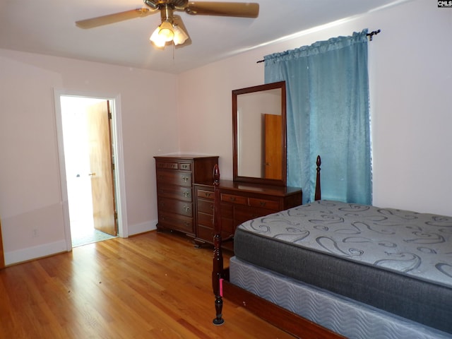 302 Baskin Ave, Bishopville, SC 29010 - bedroom featuring a ceiling fan, baseboards, and light wood finished floors