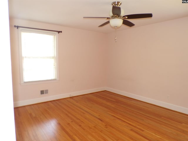302 Baskin Ave, Bishopville, SC 29010 - empty room featuring a ceiling fan, baseboards, light wood-style floors, and visible vents