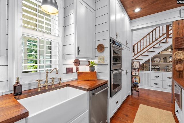 178 Pomaria St, Little Mountain, SC 29075 - kitchen with butcher block countertops, stainless steel appliances, dark wood finished floors, white cabinetry, and a sink
