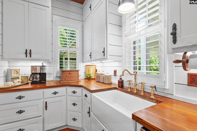 178 Pomaria St, Little Mountain, SC 29075 - kitchen with butcher block countertops, decorative backsplash, white cabinetry, and a sink