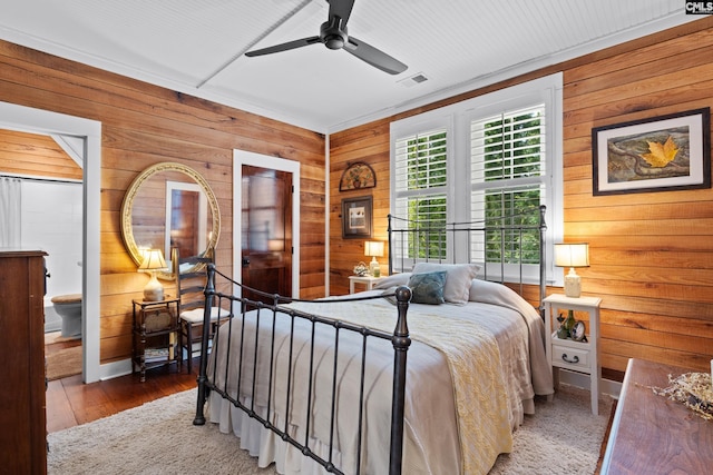 178 Pomaria St, Little Mountain, SC 29075 - bedroom featuring visible vents, wooden walls, wood finished floors, and ceiling fan