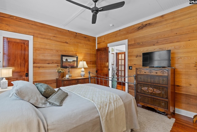 178 Pomaria St, Little Mountain, SC 29075 - bedroom with wooden walls, wood finished floors, and a ceiling fan