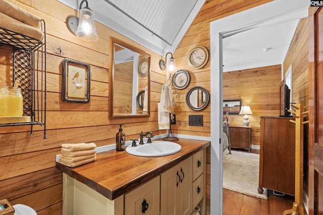 178 Pomaria St, Little Mountain, SC 29075 - bathroom with vanity, lofted ceiling, wood finished floors, and wooden walls