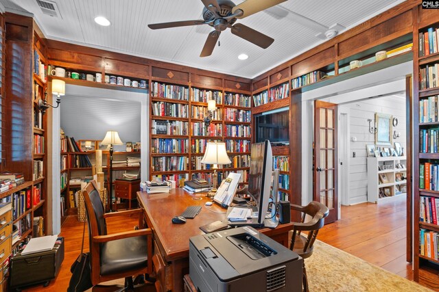 178 Pomaria St, Little Mountain, SC 29075 - home office with wood walls, wood-type flooring, visible vents, a ceiling fan, and bookshelves