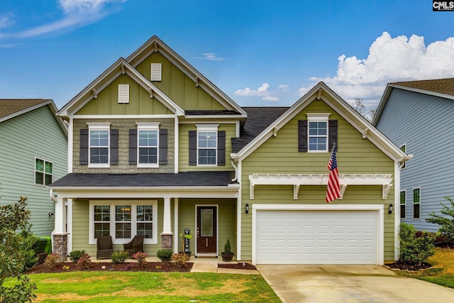 craftsman-style house featuring covered porch, board and batten siding, and concrete driveway
