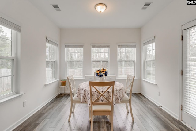 dining space featuring baseboards, visible vents, and wood finished floors