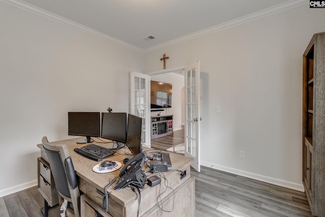 office space featuring visible vents, baseboards, ornamental molding, wood finished floors, and french doors