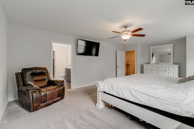 bedroom with connected bathroom, light colored carpet, ceiling fan, and baseboards