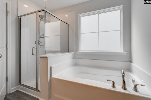 full bath featuring a bath and a shower stall