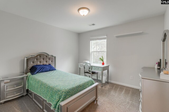 bedroom featuring baseboards, visible vents, and dark colored carpet