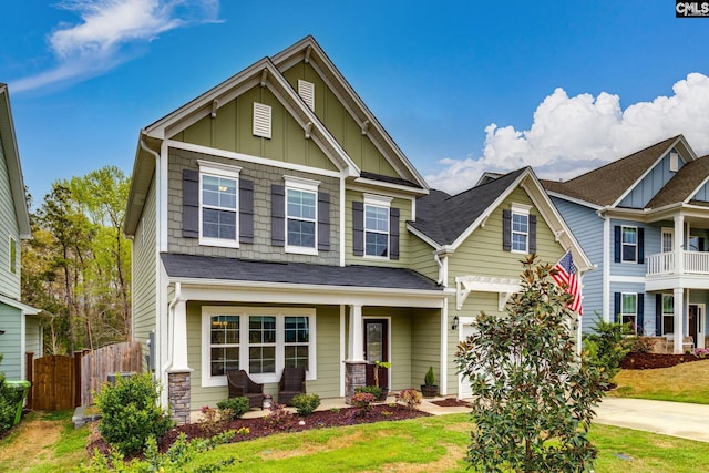 craftsman-style home with fence and board and batten siding