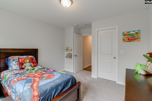 bedroom with light carpet, baseboards, and visible vents