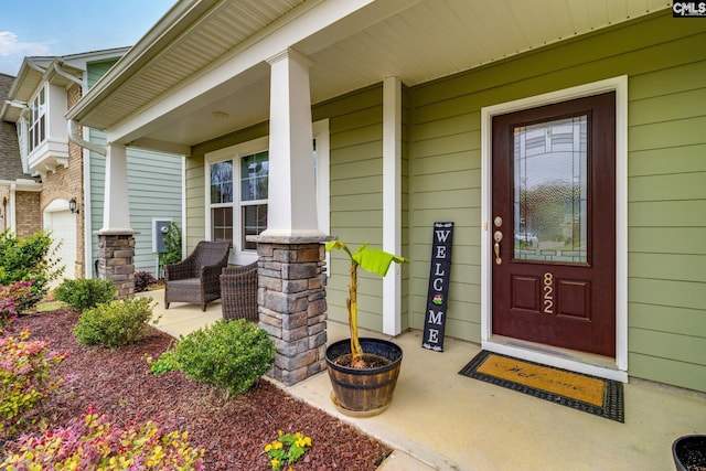 view of exterior entry with a porch