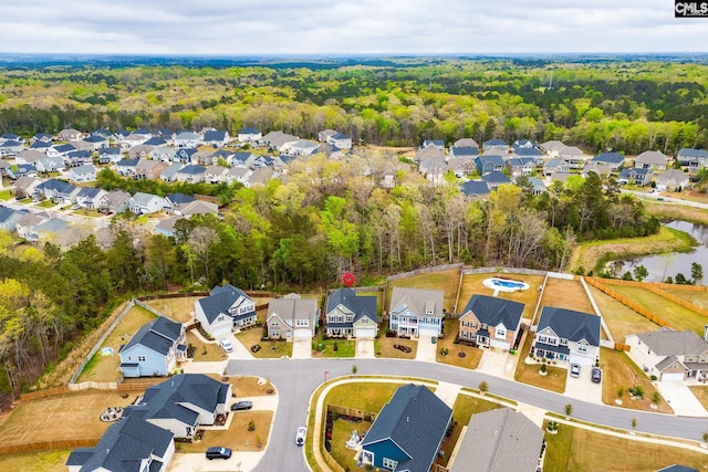 bird's eye view featuring a residential view and a wooded view