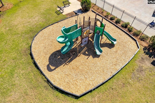 community play area featuring a lawn and fence