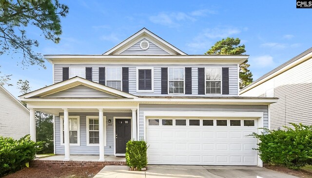 view of front facade featuring a porch, concrete driveway, and a garage
