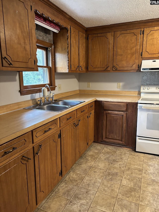 kitchen with light countertops, ventilation hood, a sink, a textured ceiling, and electric stove