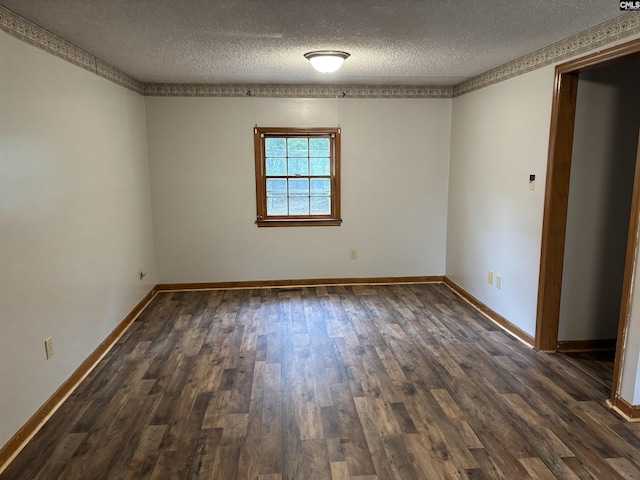 spare room with dark wood finished floors, baseboards, and a textured ceiling