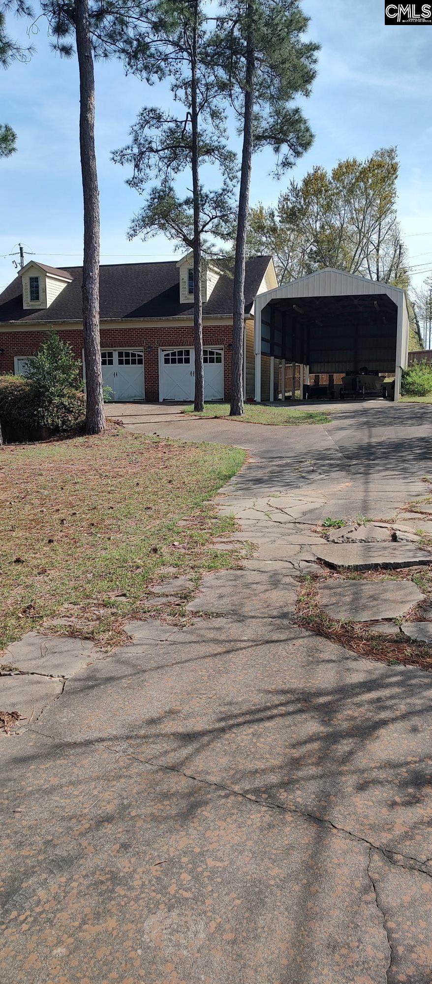 200 Arcadia Lakes Dr, Columbia, SC 29206 - view of front of property featuring brick siding, concrete driveway, and a carport