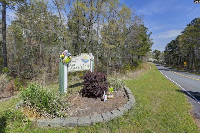 community / neighborhood sign with a lawn