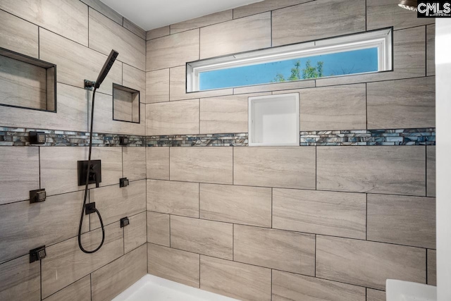 bathroom with a tile shower