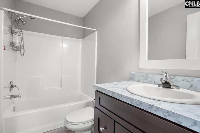 bathroom with bathtub / shower combination, toilet, and vanity