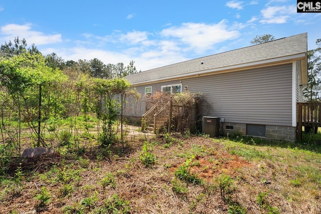rear view of house featuring crawl space and central AC unit