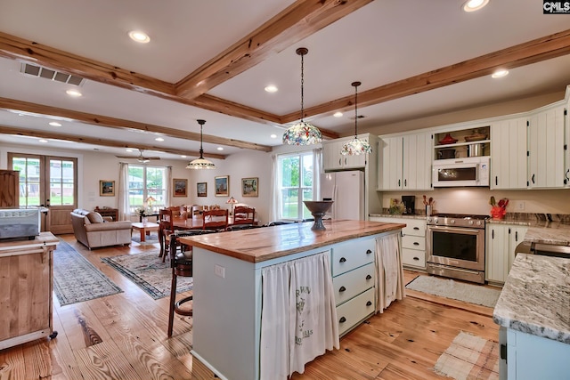 kitchen featuring visible vents, white appliances, beam ceiling, open shelves, and light wood-style floors