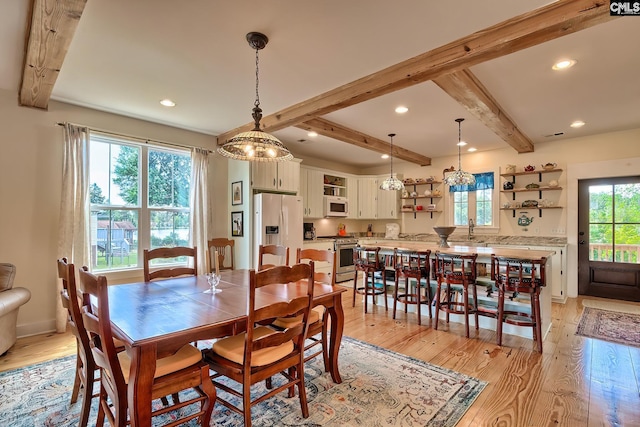 dining area featuring beam ceiling, light wood finished floors, and recessed lighting