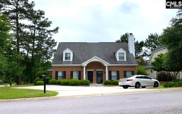 103 Saddlechase Ln, Columbia, SC 29223 - cape cod house with driveway, brick siding, a chimney, and a front yard