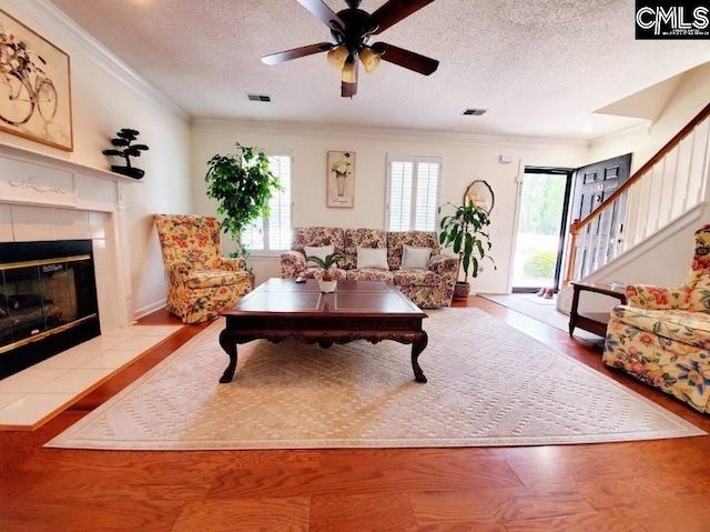 103 Saddlechase Ln, Columbia, SC 29223 - living area with a textured ceiling, ornamental molding, a tile fireplace, and a ceiling fan