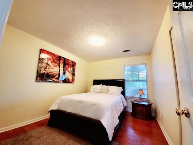 103 Saddlechase Ln, Columbia, SC 29223 - bedroom with wood finished floors, a textured ceiling, baseboards, and visible vents