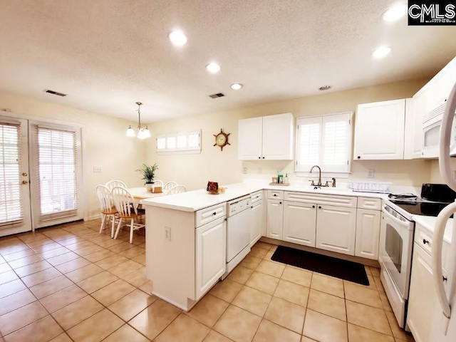 103 Saddlechase Ln, Columbia, SC 29223 - kitchen with visible vents, a peninsula, white appliances, white cabinetry, and an inviting chandelier