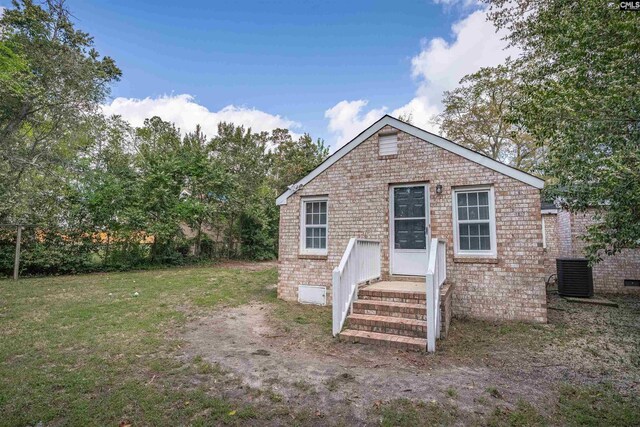 1565 Mayer St, Columbia, SC 29203 - view of front of house featuring central air condition unit and a front yard