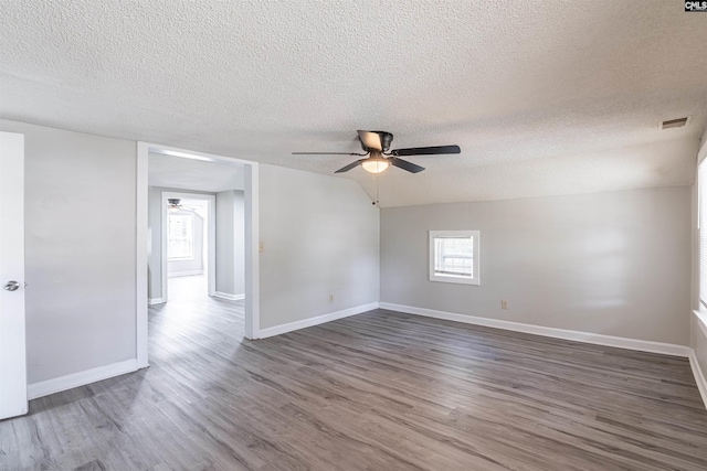 1565 Mayer St, Columbia, SC 29203 - unfurnished room featuring a textured ceiling, visible vents, baseboards, ceiling fan, and dark wood-type flooring