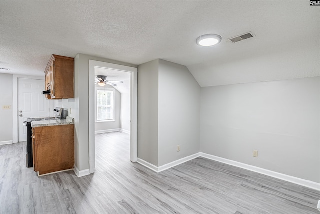 1565 Mayer St, Columbia, SC 29203 - additional living space with lofted ceiling, baseboards, a textured ceiling, light wood-style floors, and visible vents