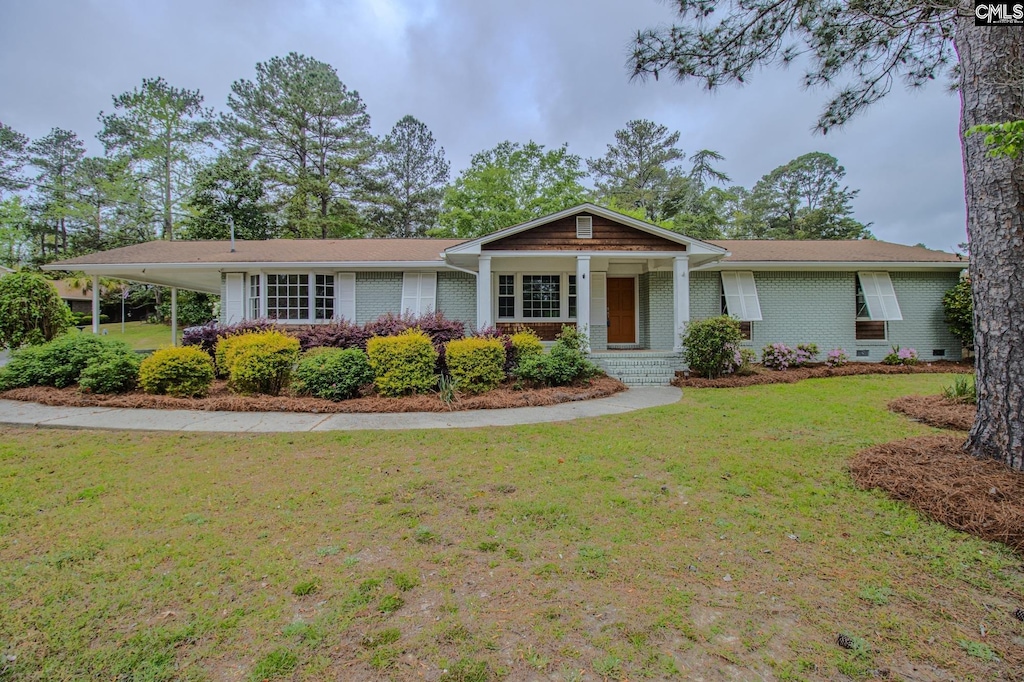 4437 Willingham Dr, Columbia, SC 29206 - ranch-style house with brick siding, a front lawn, and a carport