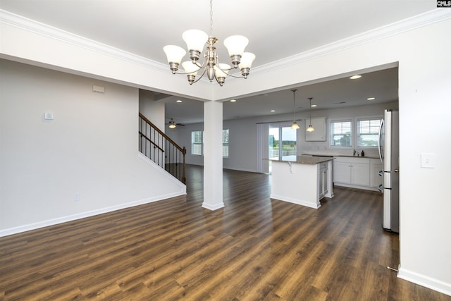 unfurnished living room with baseboards, dark wood-style flooring, recessed lighting, and crown molding