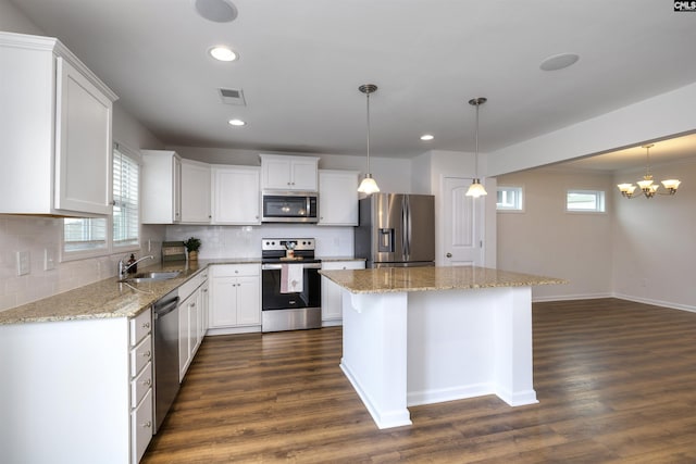 kitchen featuring dark wood finished floors, visible vents, a sink, and stainless steel appliances