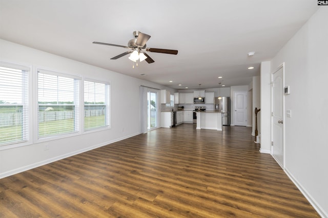 unfurnished living room featuring dark wood-type flooring, ceiling fan, baseboards, and recessed lighting