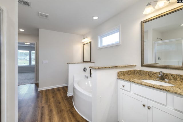 full bathroom featuring a bath, visible vents, wood finished floors, and an enclosed shower