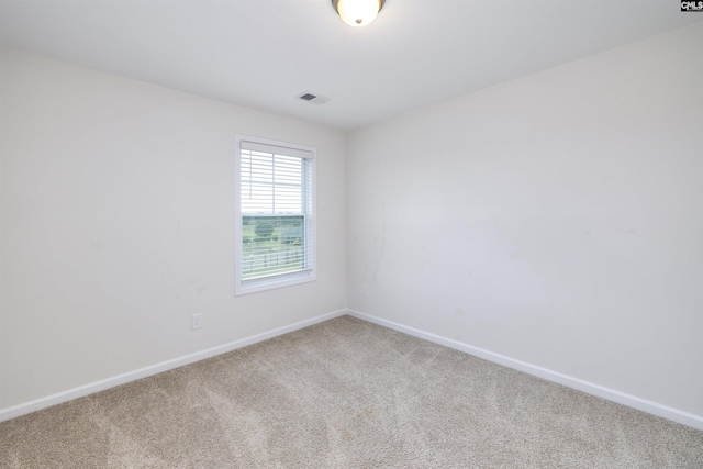 carpeted spare room with baseboards and visible vents
