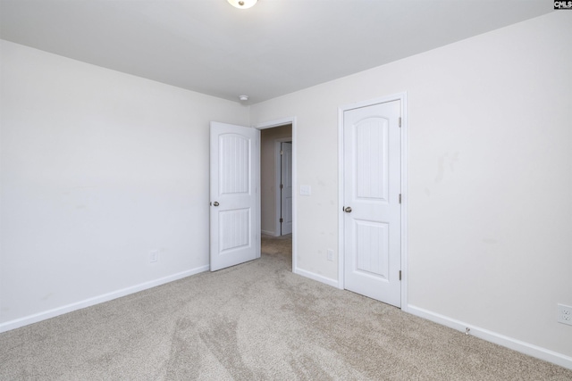 unfurnished bedroom with baseboards and carpet floors