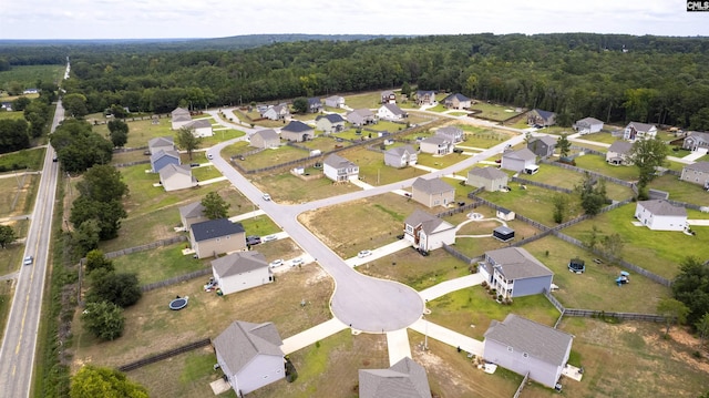 birds eye view of property with a residential view and a wooded view