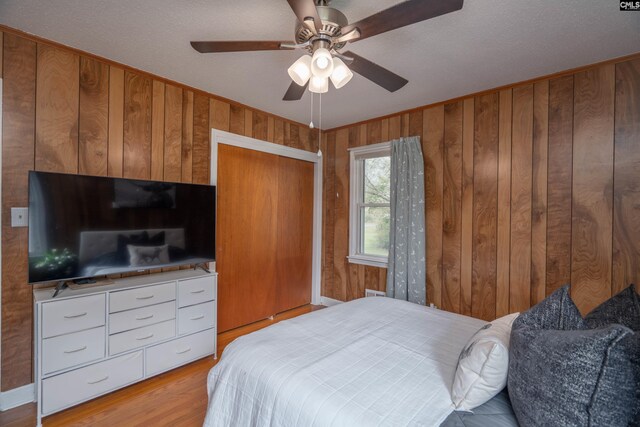 2008 Arnett Dr, Camden, SC 29020 - bedroom with wooden walls, light wood-style floors, and ceiling fan