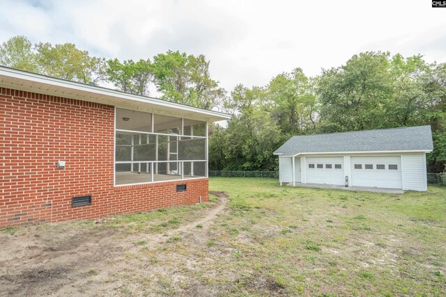2008 Arnett Dr, Camden, SC 29020 - view of yard featuring an outdoor structure, a sunroom, a garage, and fence