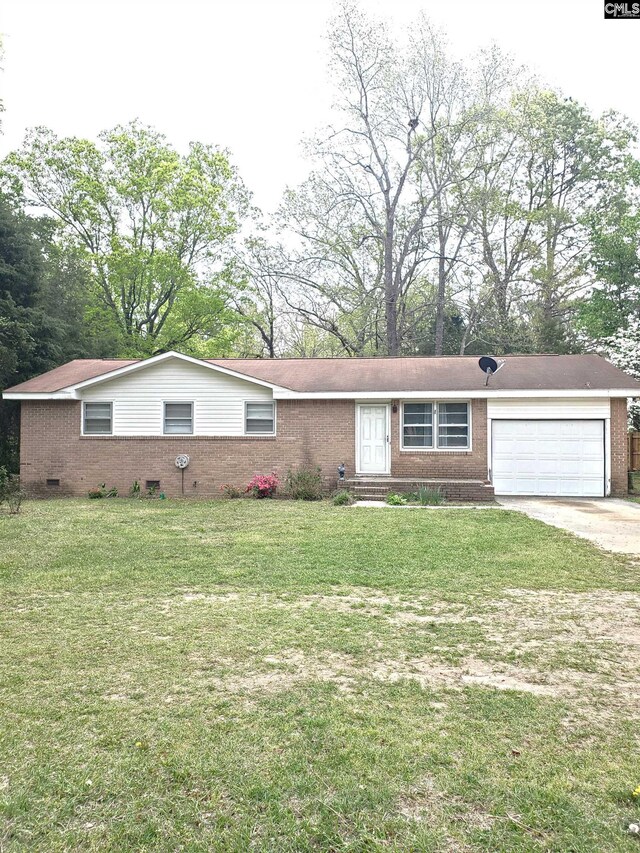 ranch-style home featuring an attached garage, concrete driveway, a front yard, and brick siding
